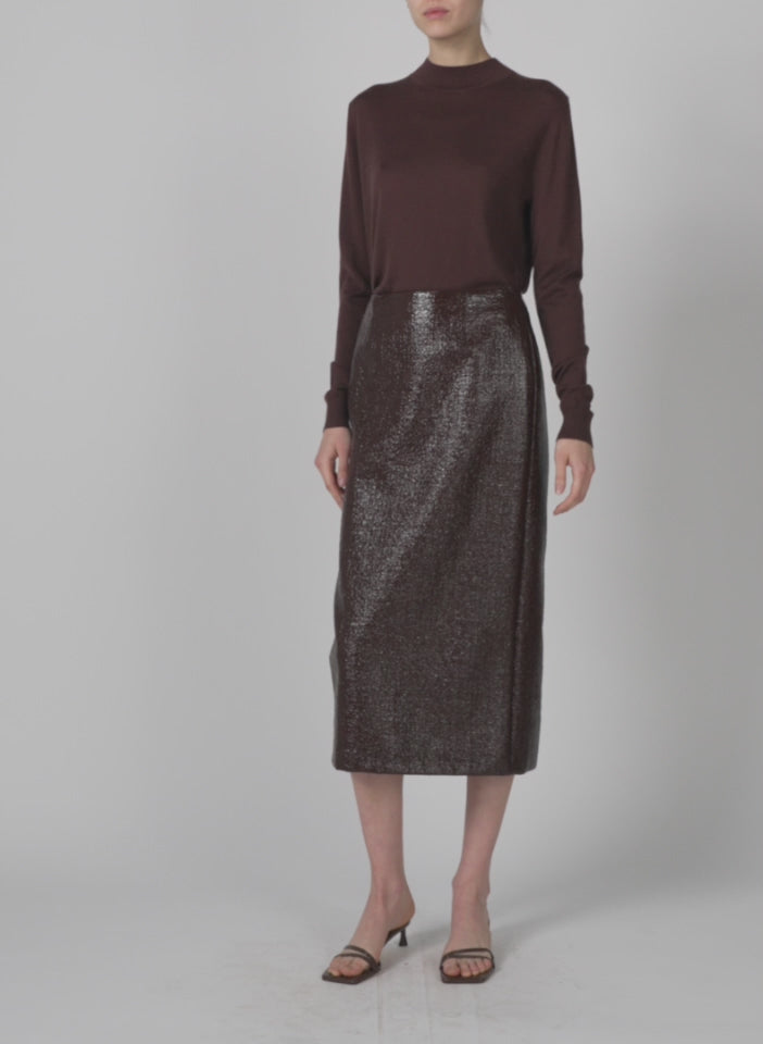 Model wearing the coated basketweave pencil skirt brown walking forward and turning around