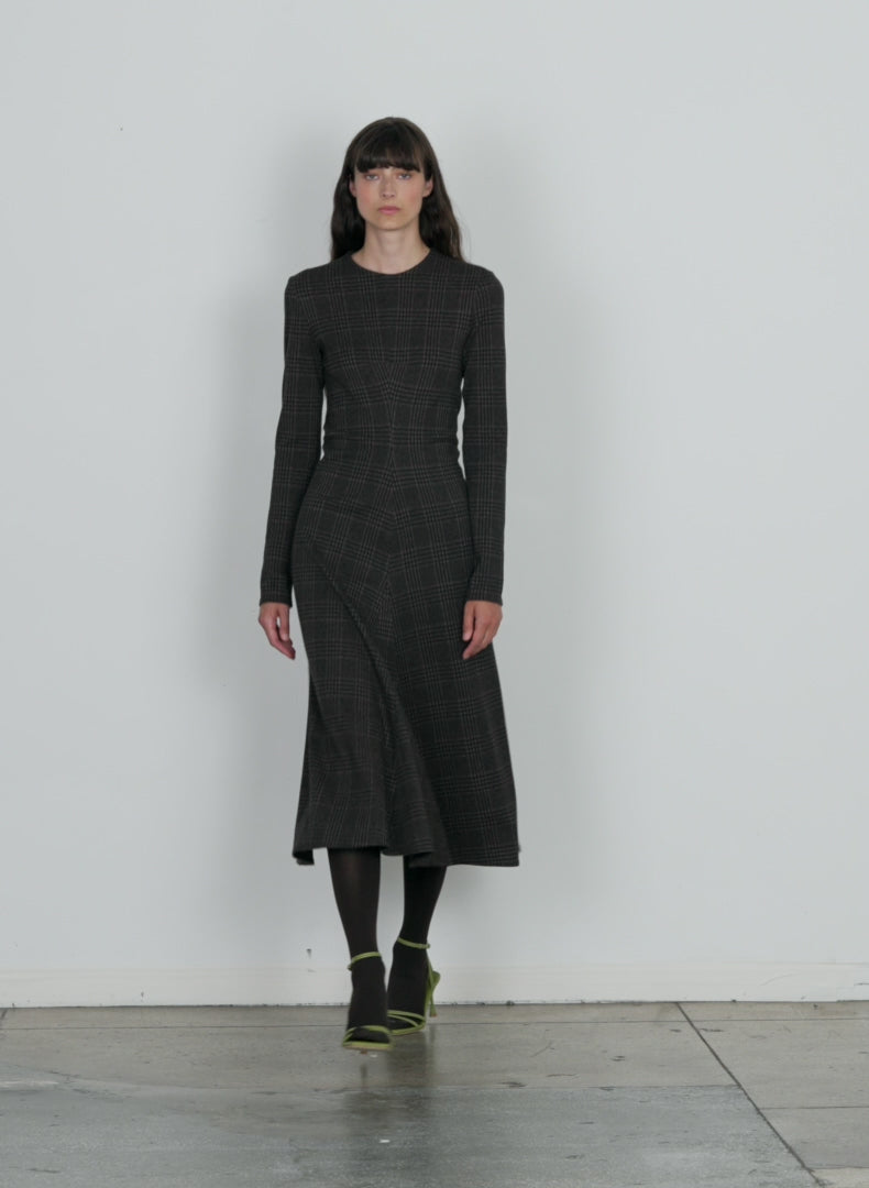Model wearing the lutz knit midi godet dress brown black multi walking forward and turning around