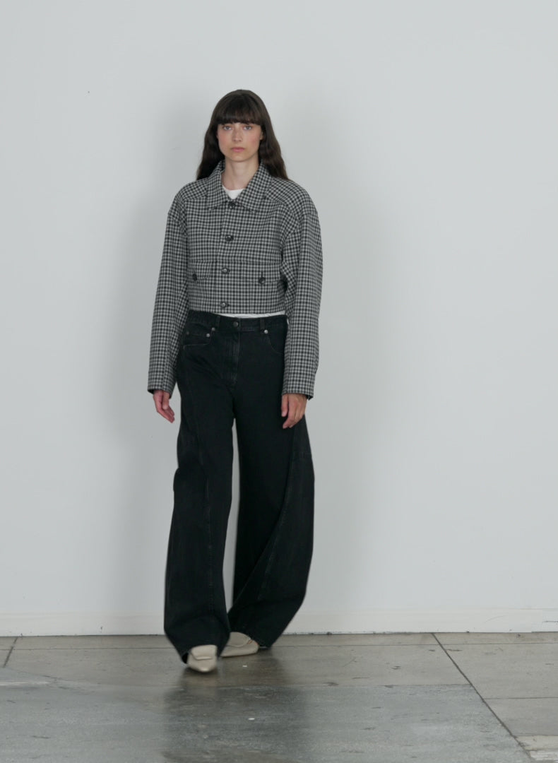Model wearing the black denim sid jean black walking forward and turning around