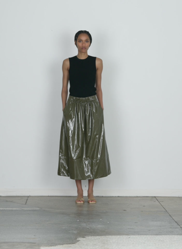 Model wearing the light weight stretch patent smocking waistband full skirt wood walking forward and turning around
