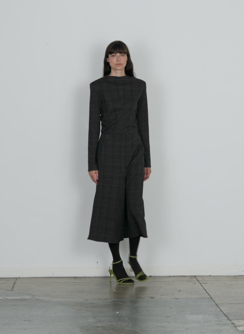 Model wearing the lutz knit godet midi skirt brown black multi walking forward and turning around