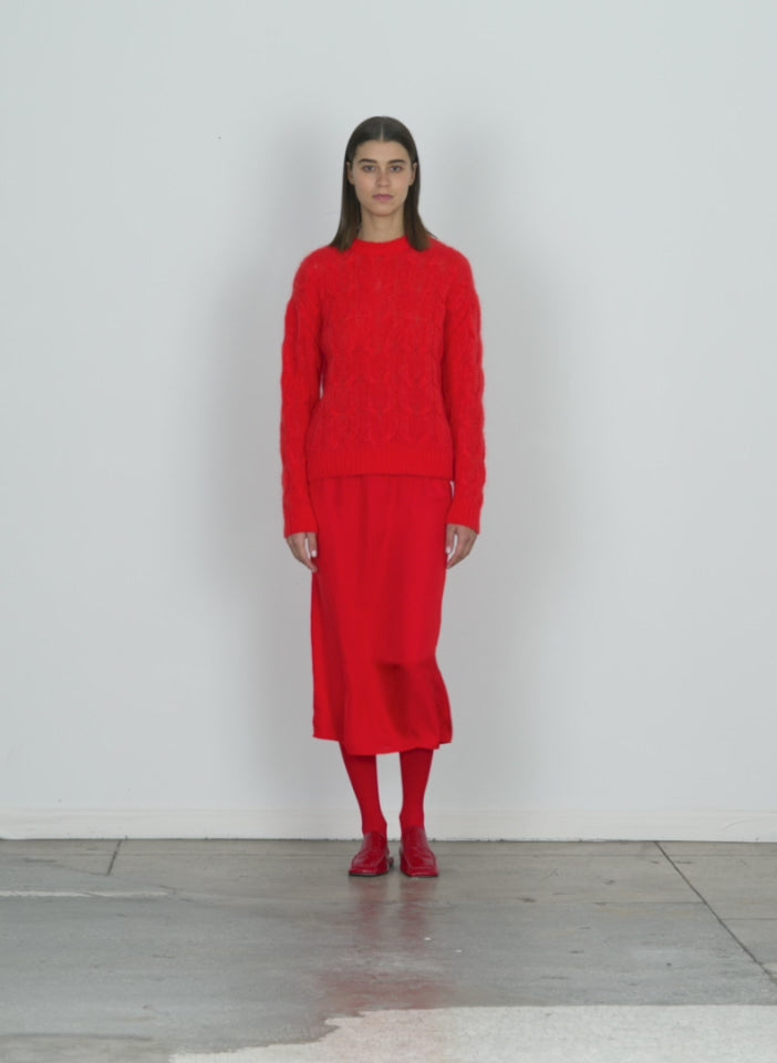 Model wearing the soft mohair cable crewneck easy pullover red  walking forward and turning around