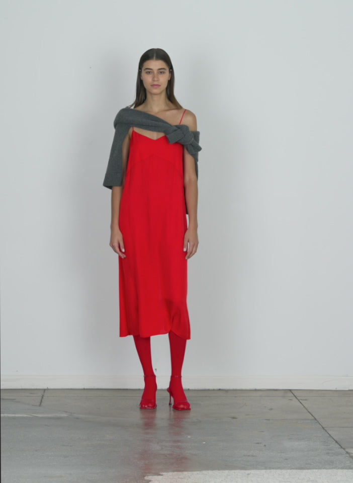 Model wearing the slip dress red walking forward and turning around
