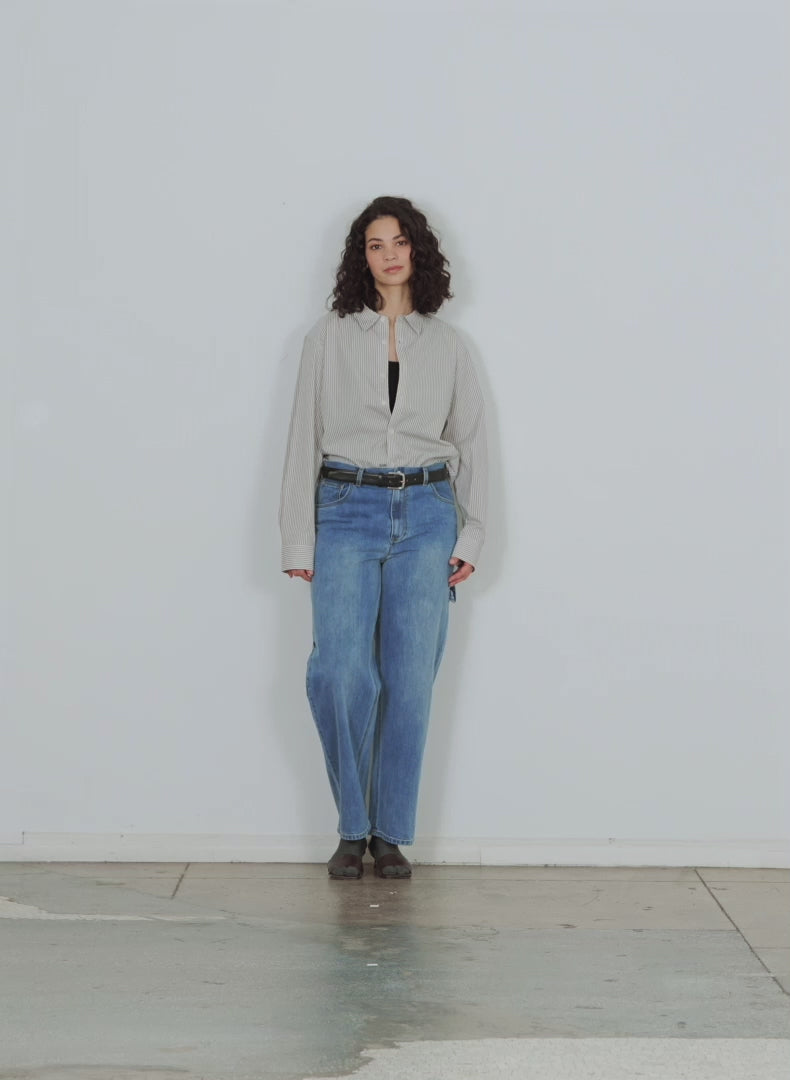 Model wearing the classic denim sam jean walking forward and turning around