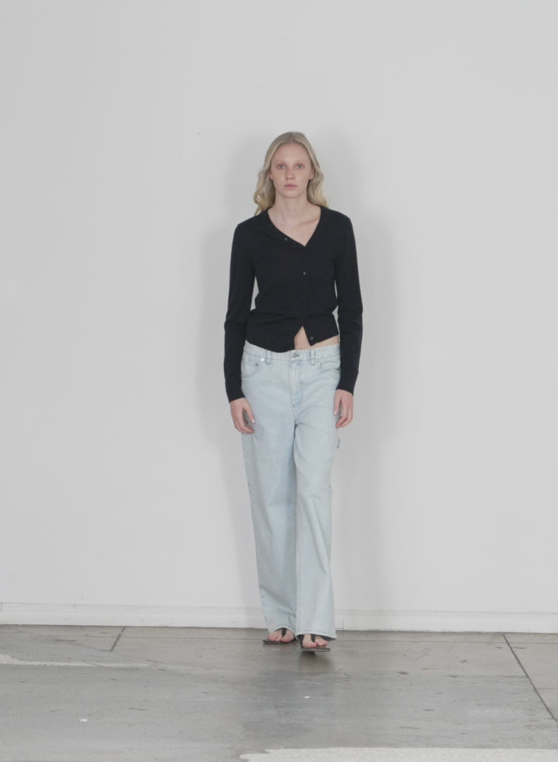 Model wearing the bleach denim sam jean bleached denim walking forward and turning around