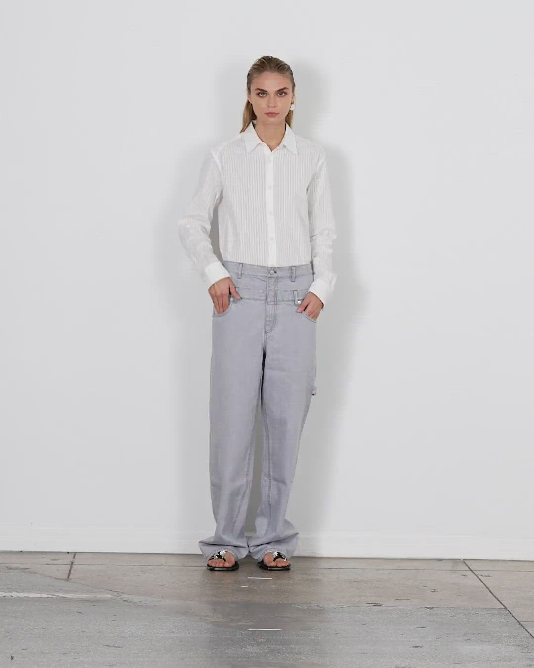 Model wearing the grey denim dbl waisted sam jean walking forward and turning around