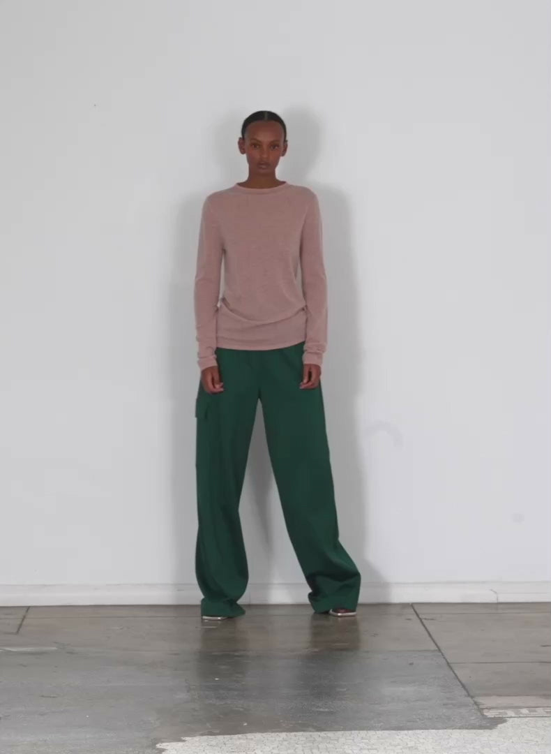 Model wearing the skinlike mercerized wool soft sheer pullover toffee brown walking forward and turning around