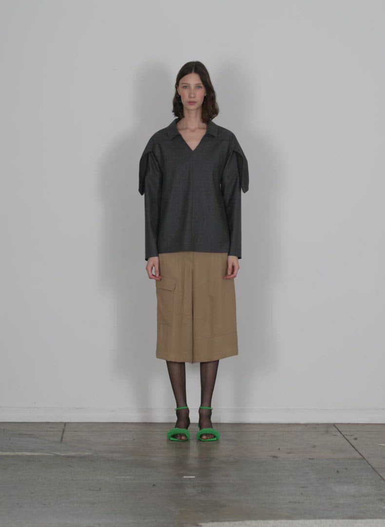 Model wearing the eco acetate viscose cargo short tan walking forward and turning around