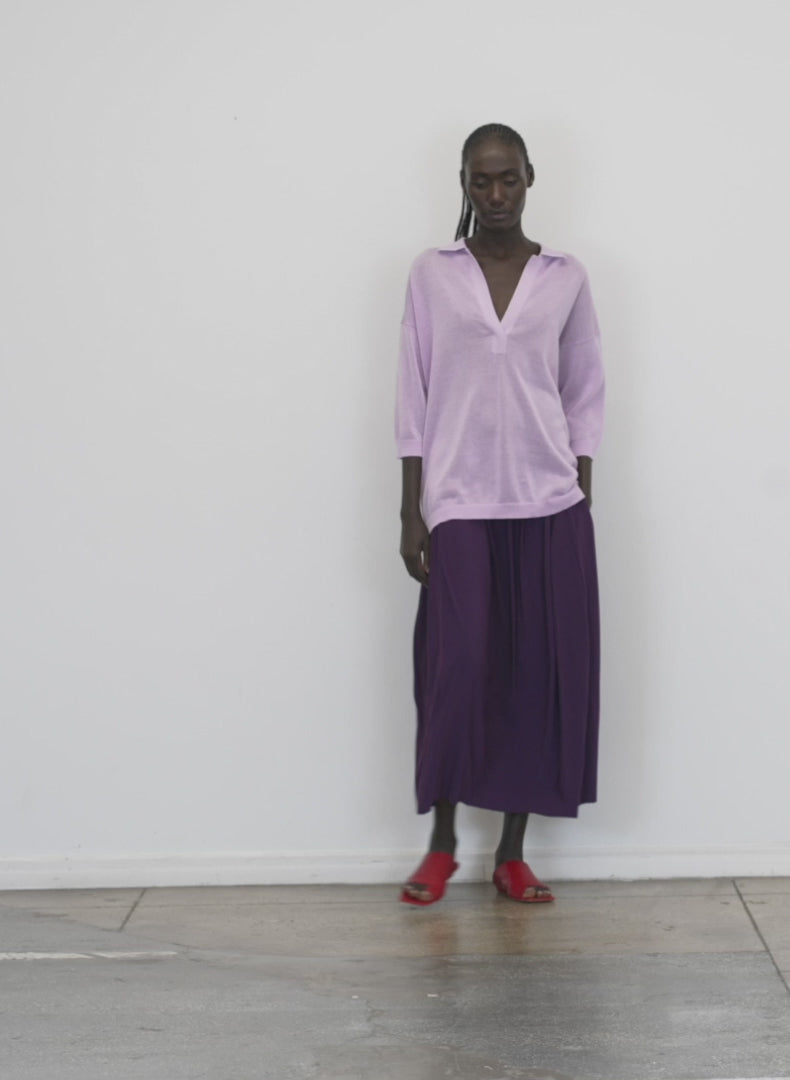 Model wearing the crispy viscose sweater easy polo dusty lavender walking forward and turning around