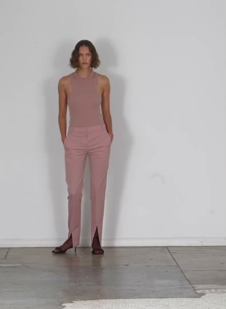 Model wearing the cassius suiting slim pant with front slit detail toffee walking forward and turning around