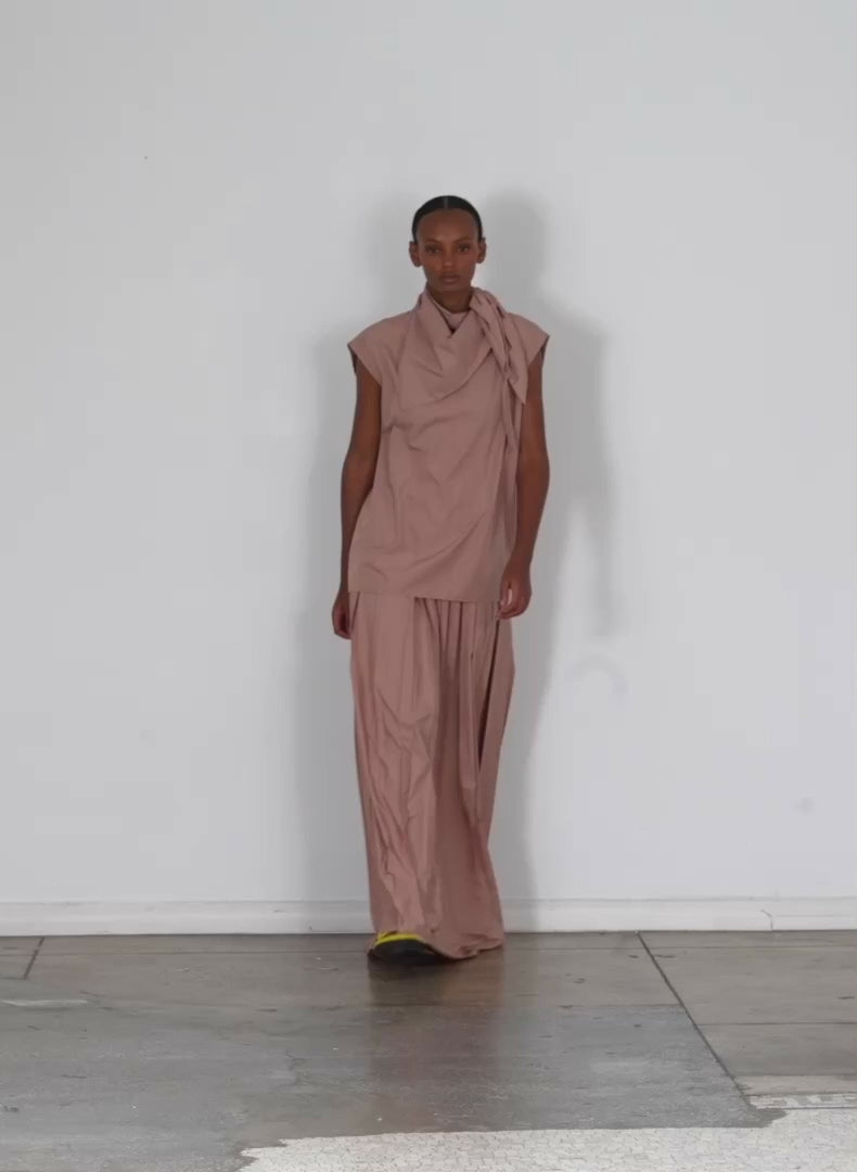 Model wearing the italian sporty nylon sleeveless cocoon top toffee walking forward and turning around