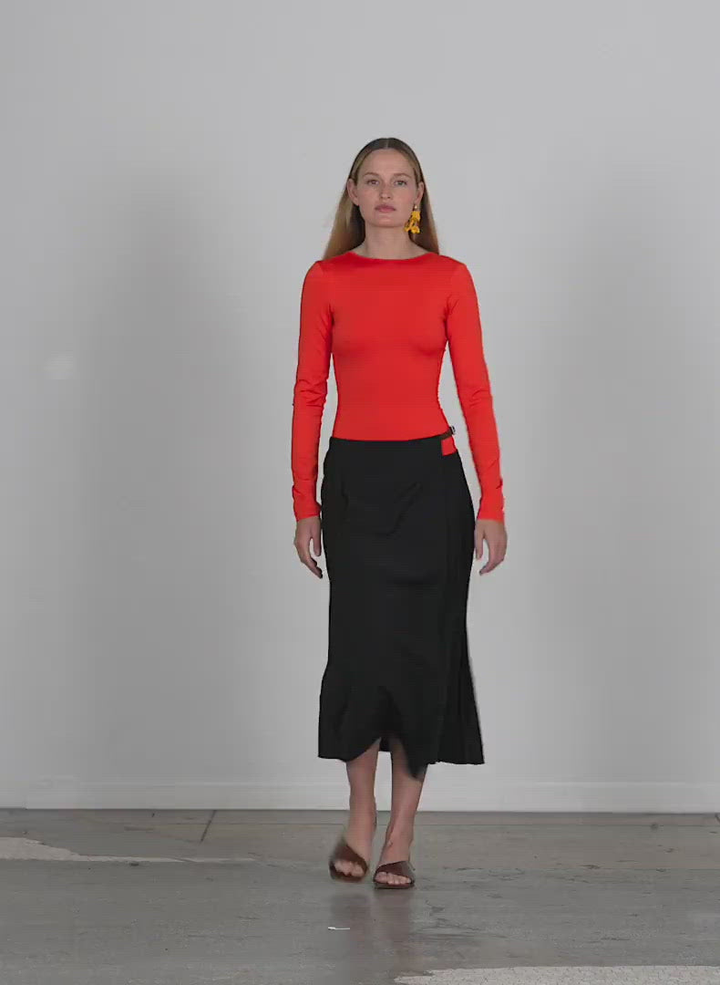 Model wearing the tropical wool pleated leather waist belt wrap skir walking forward and turning around