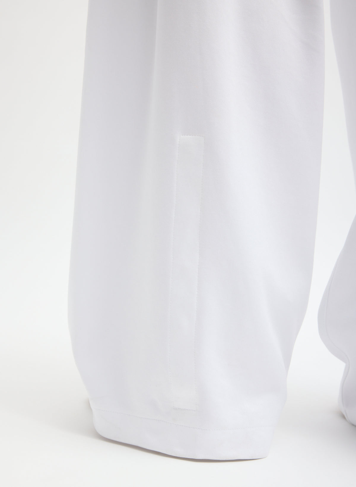 White Active Knit Winslow Pant - closeup of snap detail at hem