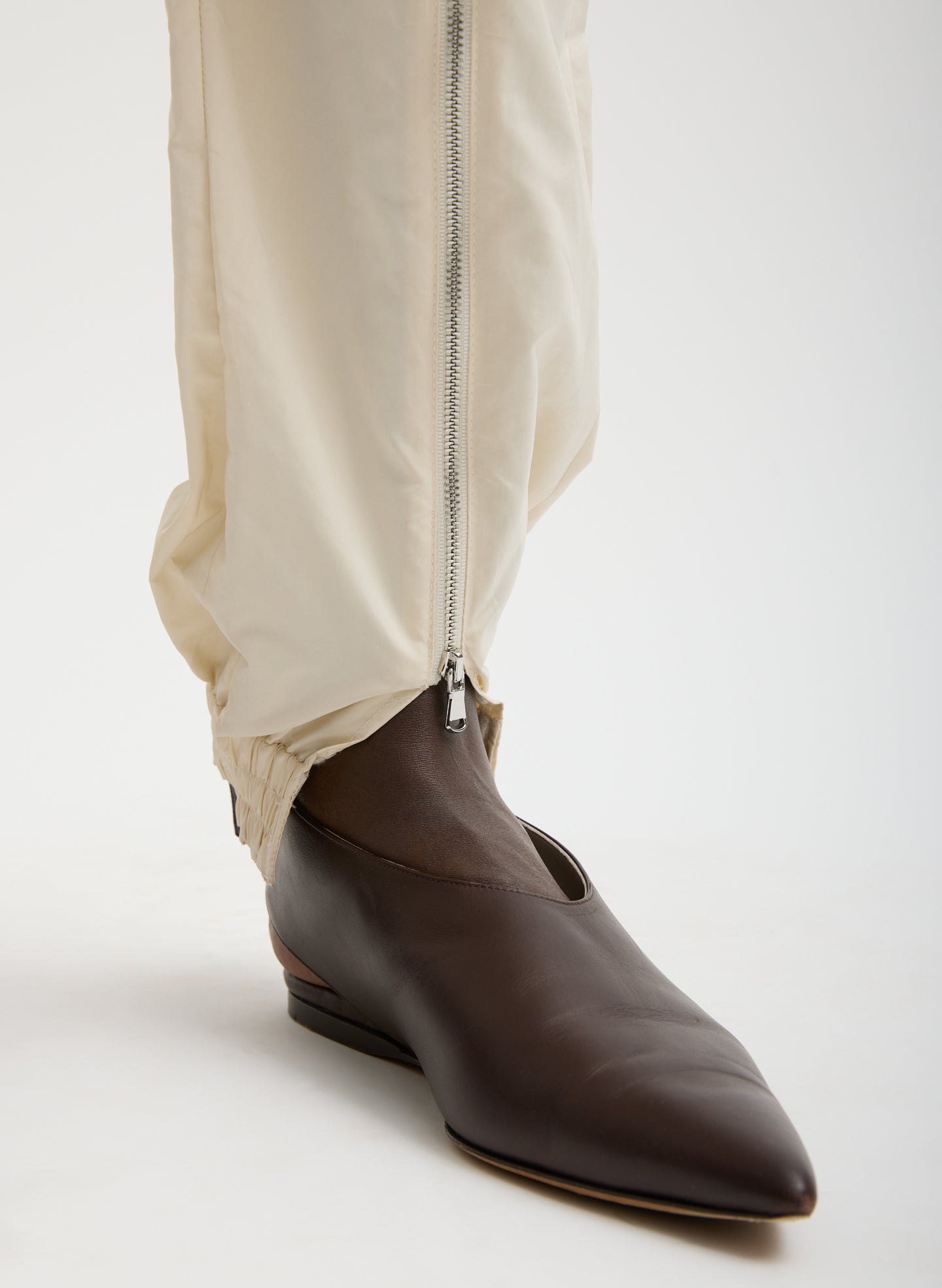 Ivory Nylon Zipper Jogger - close up of ankle and front zipper detail
