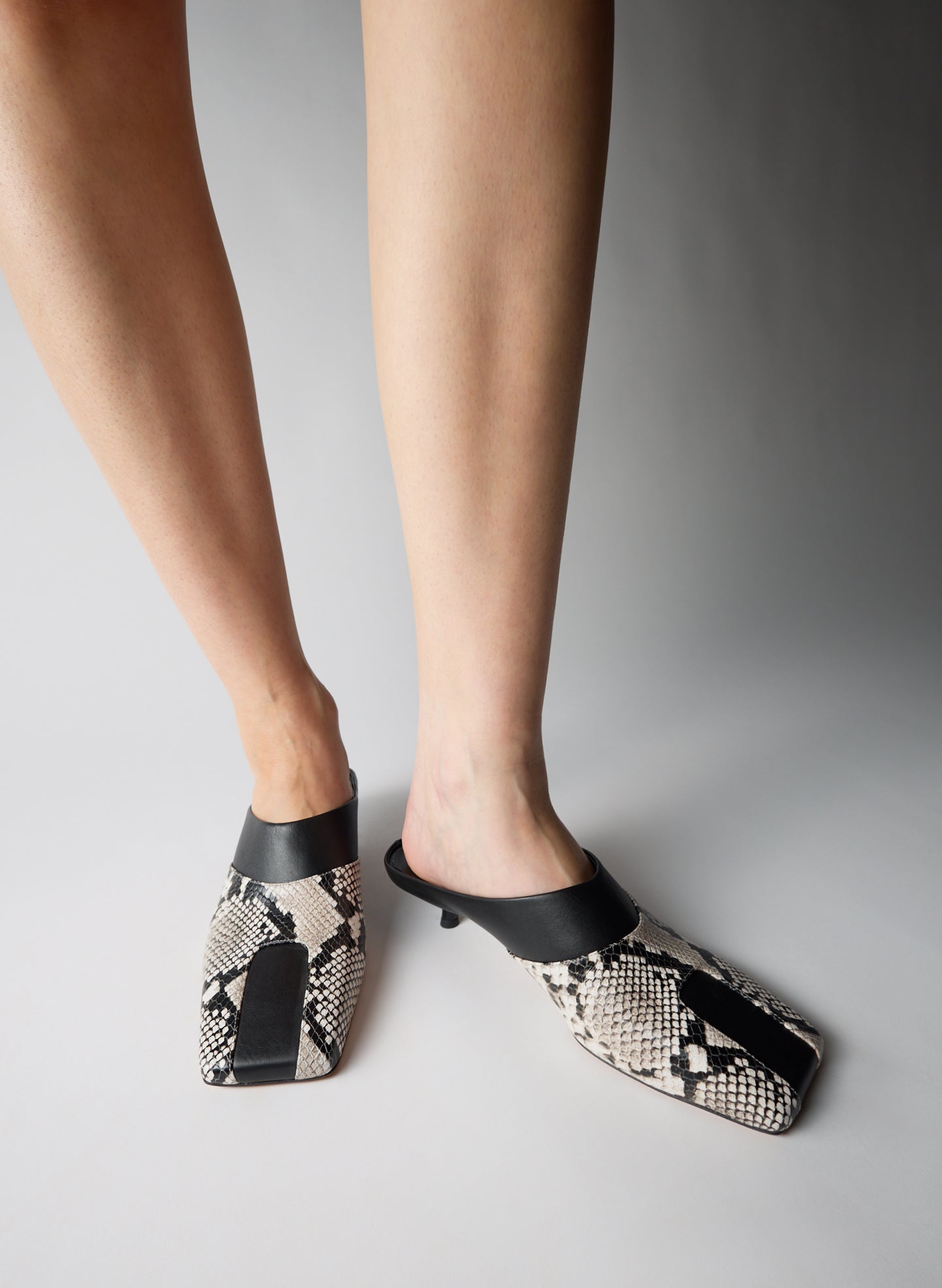 Two Tone Black and Snake Embossed Leather Gwinnett Heeled Mule - on model