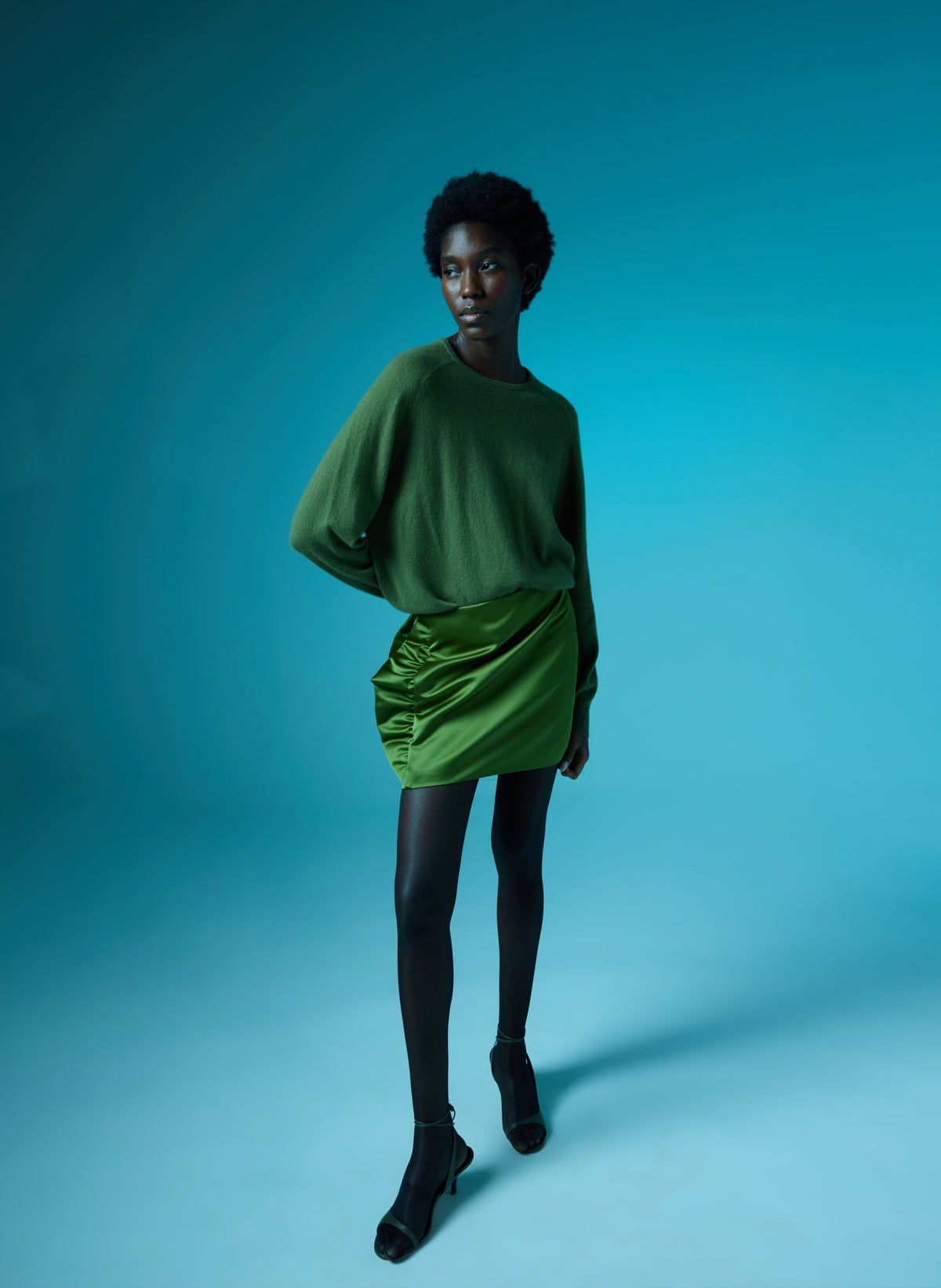Green Feather Weight Cashmere Sweater and Satin Mini Skirt - editorial image on model