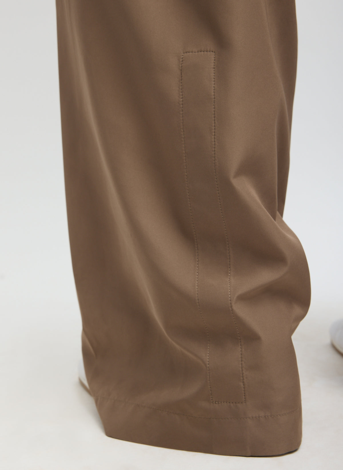 Dark Stone Spring Nylon Winslow Pant - closeup of button details at hem