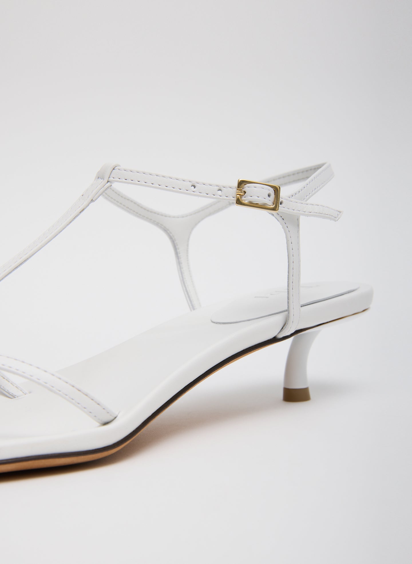 White Christopher Heel - closeup of leather strap and buckle detail