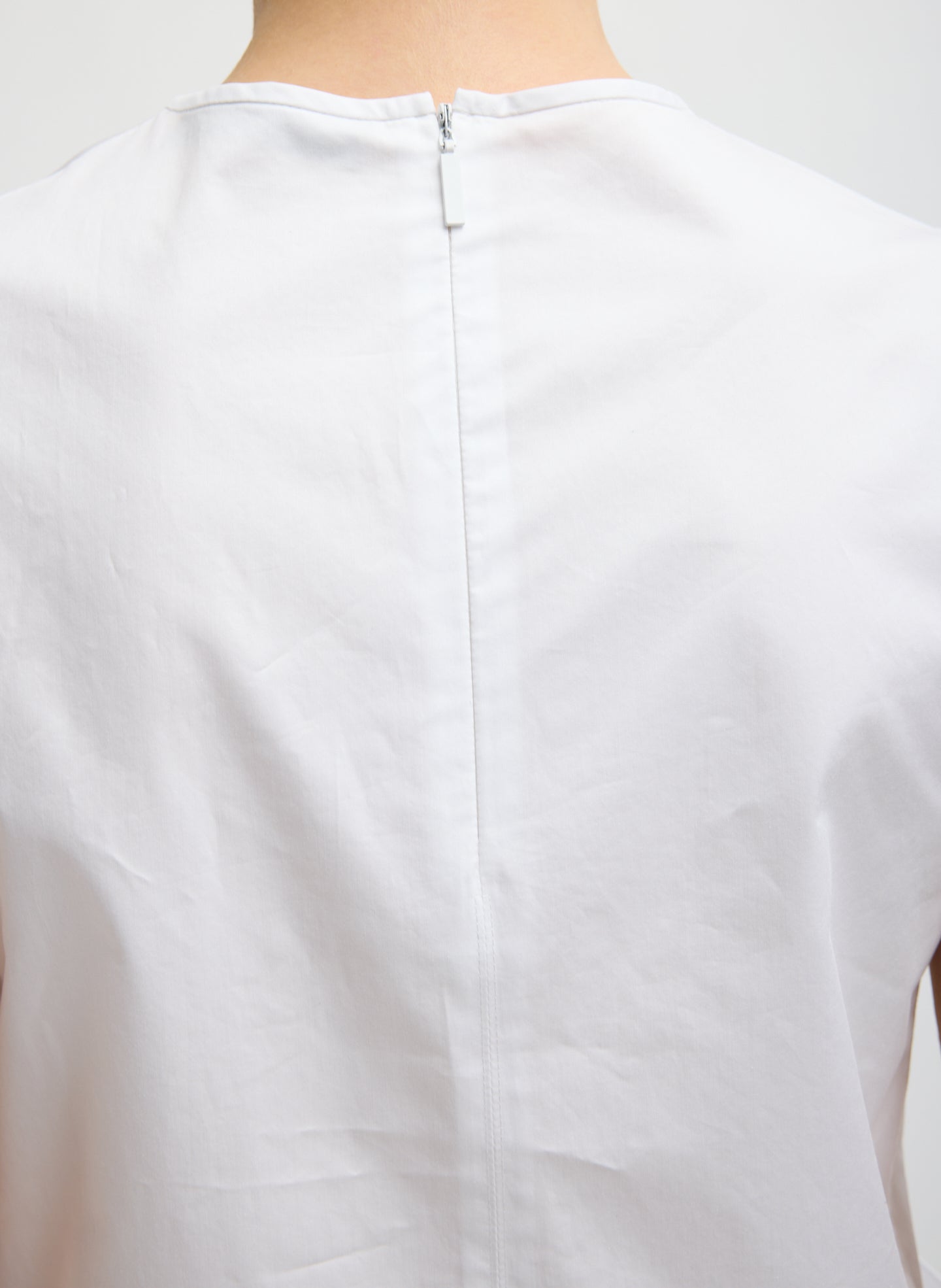White Eco Poplin Side Drape Top - closeup of zip detail at back