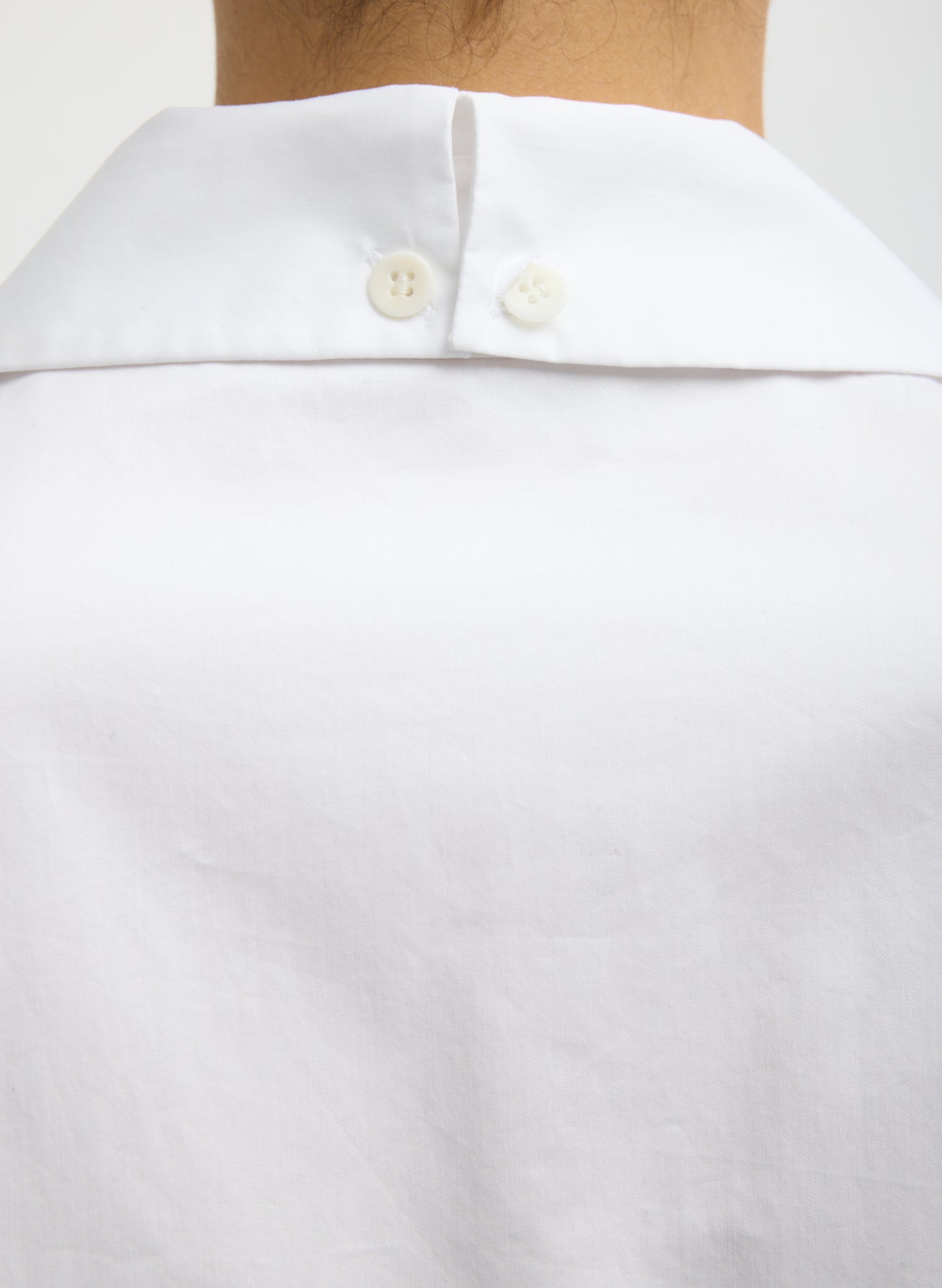 White Eco Poplin Easy Shirt with Flap Detail - closeup of button detail at collar