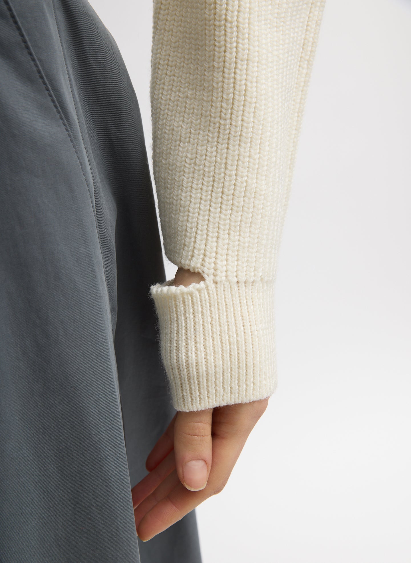 Ivory Cardigan Stitch Wool Shrunken Crewneck Pullover - closeup of cutout detail at wrist