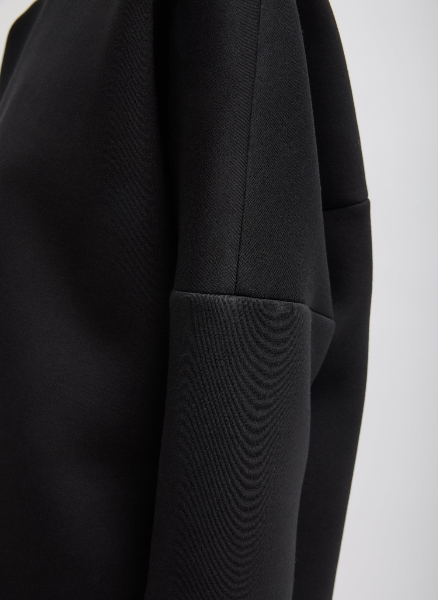 Black Structured Viscose Neck Dolman Sleeve Top - closeup of stitch detail at sleeve