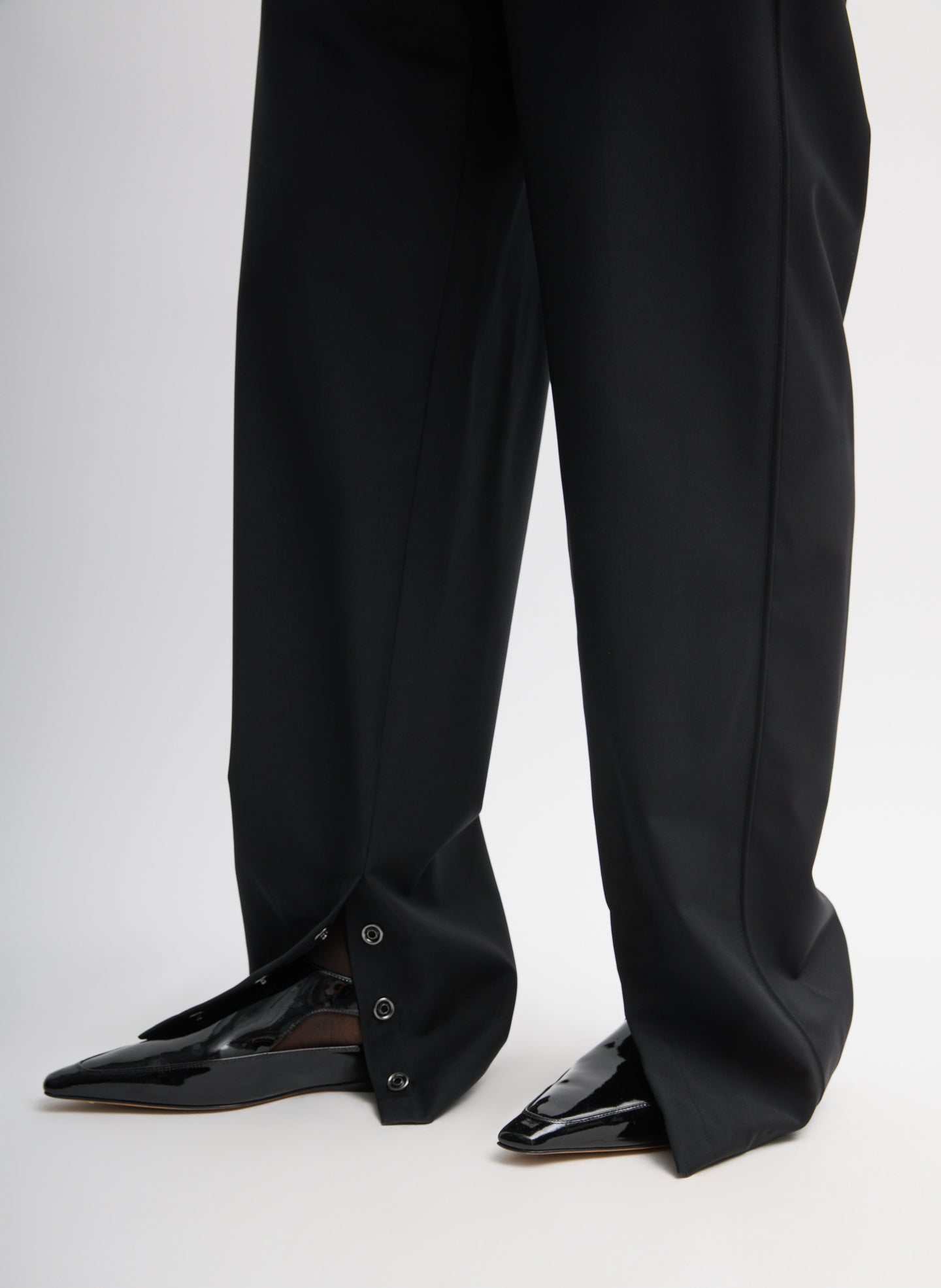 Black Recycled Tropical Wool Jules Trouser - closeup of snap hem detail