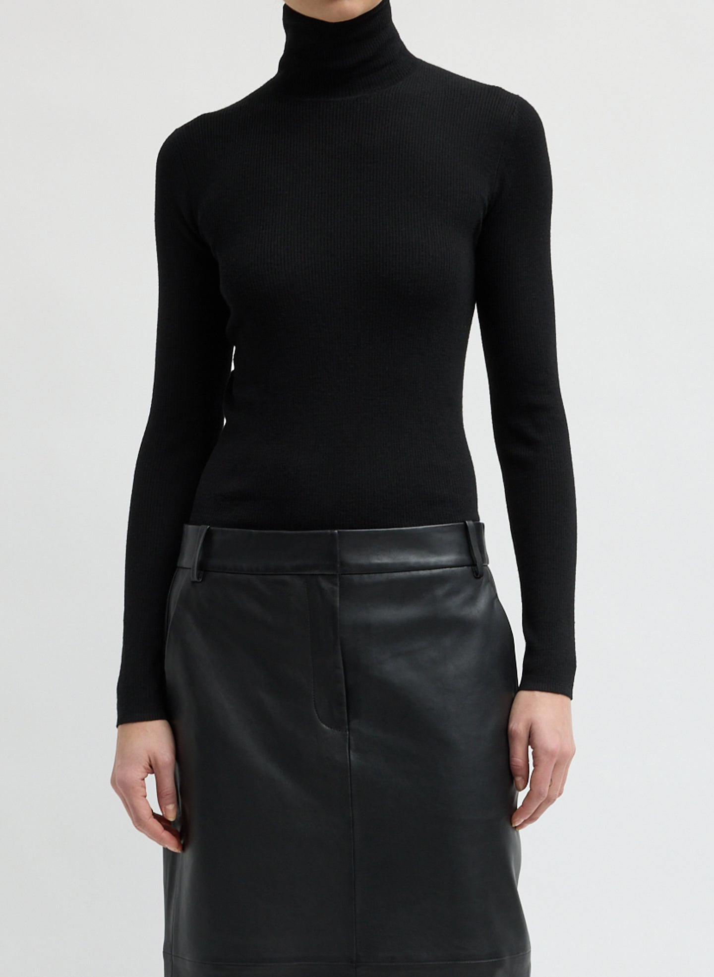 Black Feather Weight Ribbed Turtleneck - front view on model