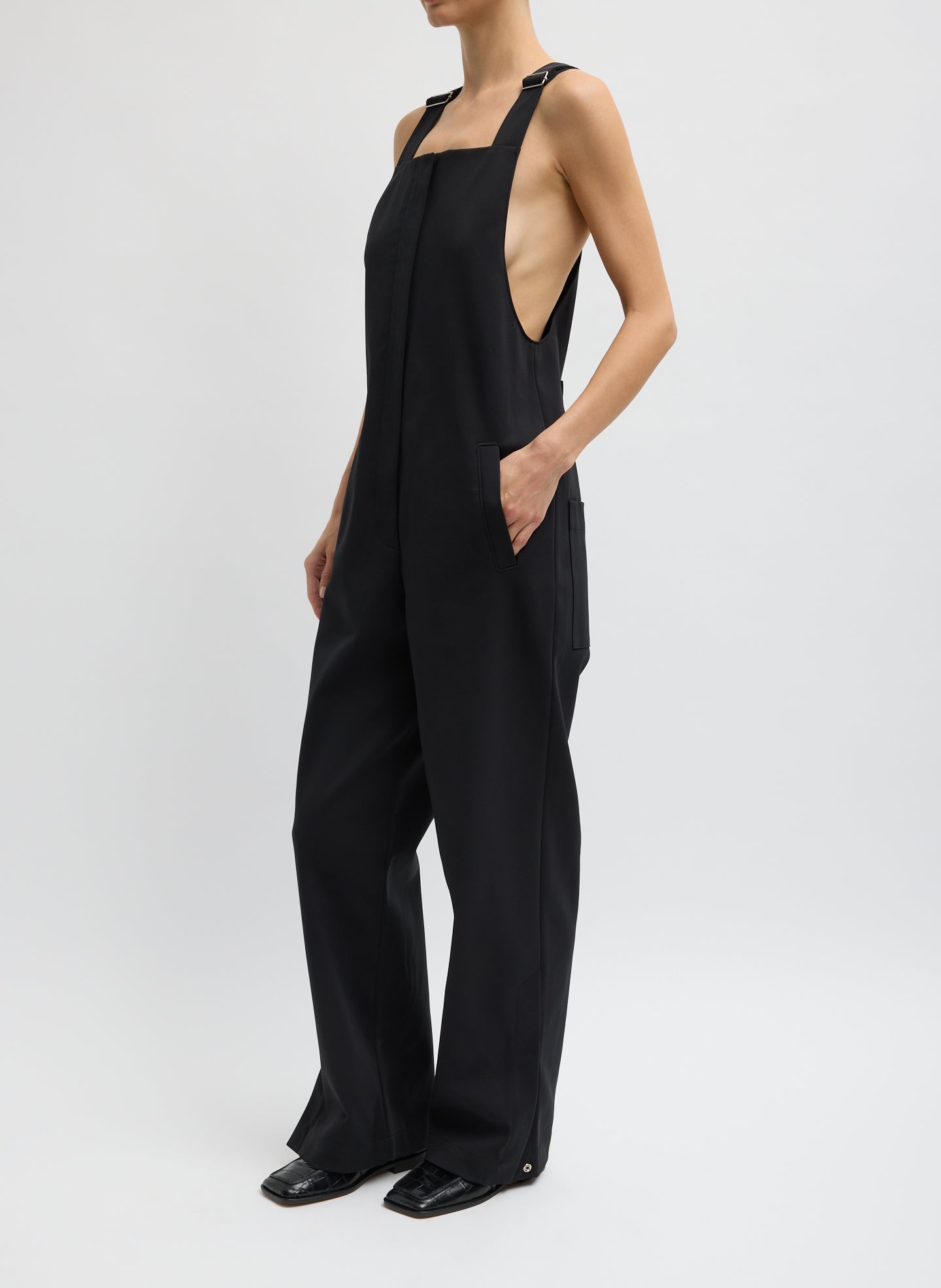 Black Compact Tech Knit Overalls - full look, side view on model