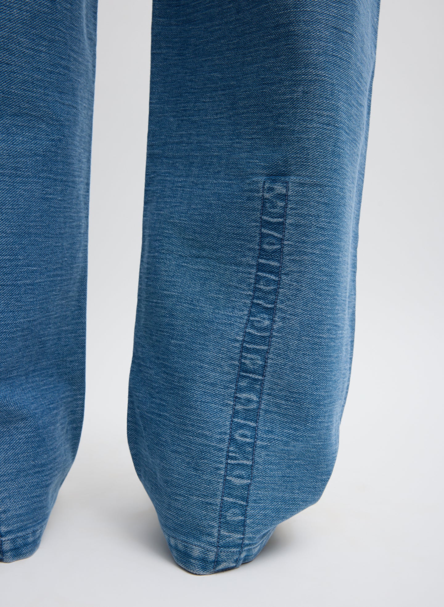 Classic Blue Denim Interlock Mica Jean - closeup of hidden snap details at hem