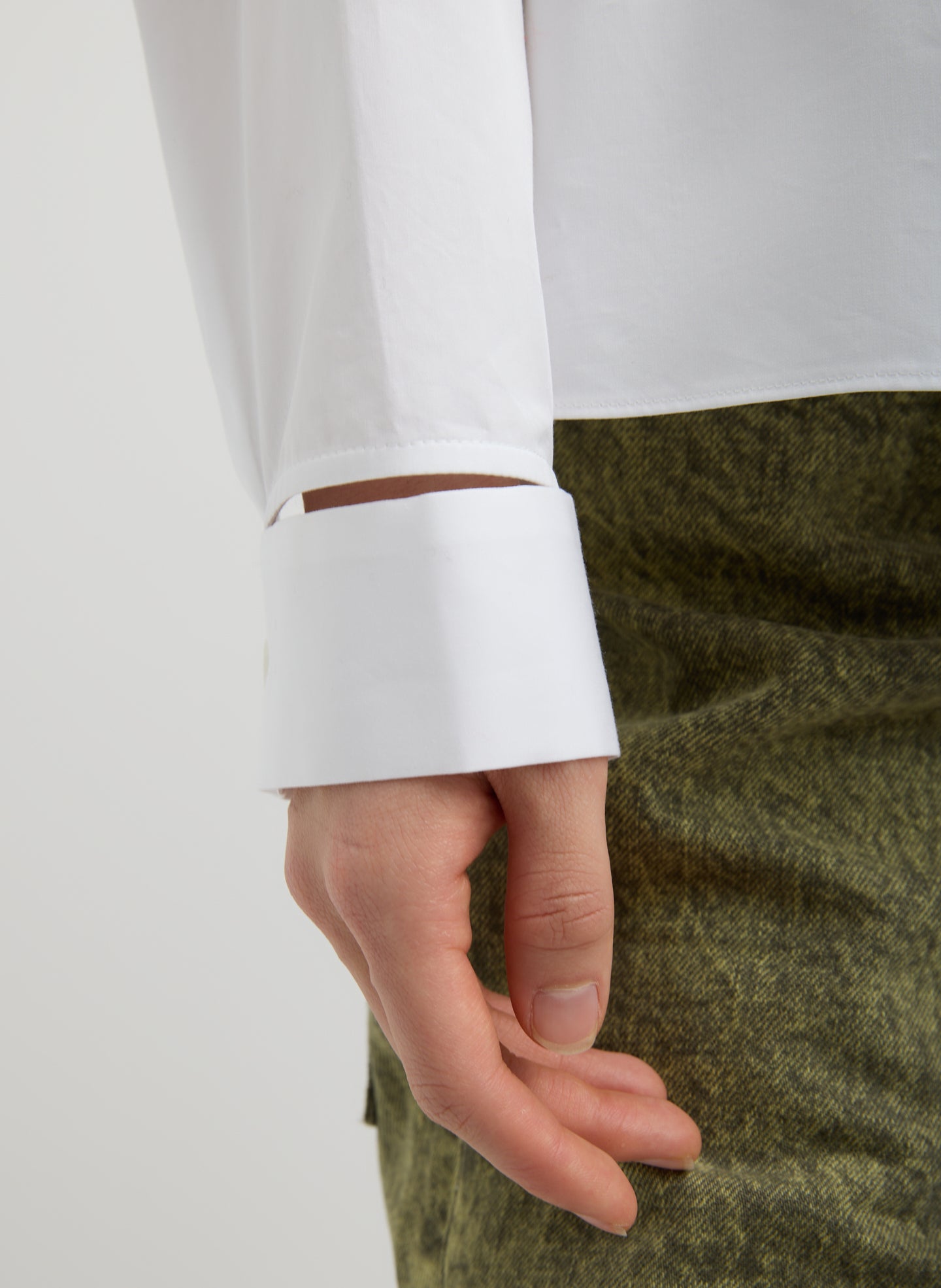 White Eco Poplin Funnel Neck Dolman Top - closeup of slit detail at wrist
