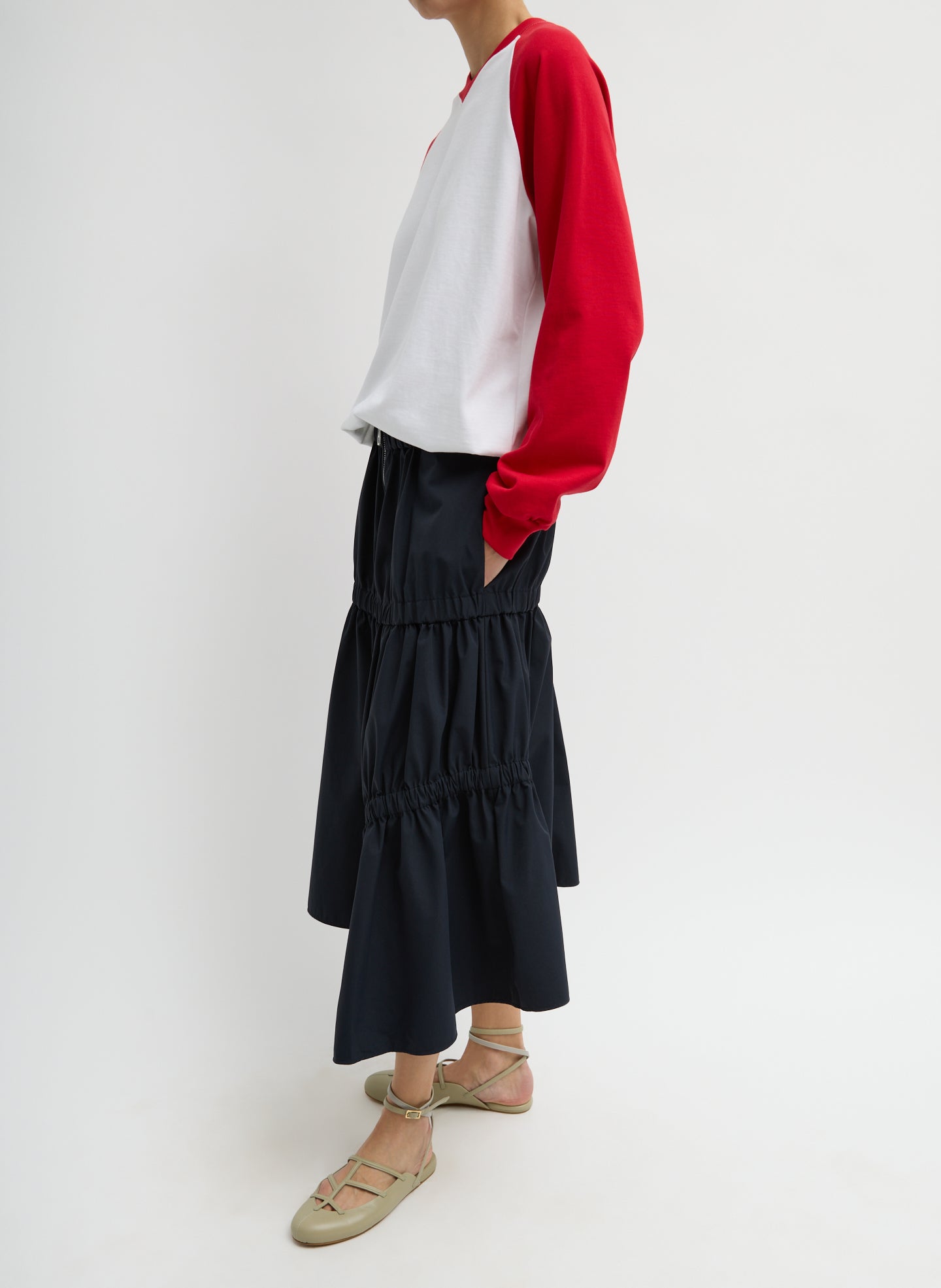 Black Tech Suiting Asymmetrical Skirt - zip up, side view on model