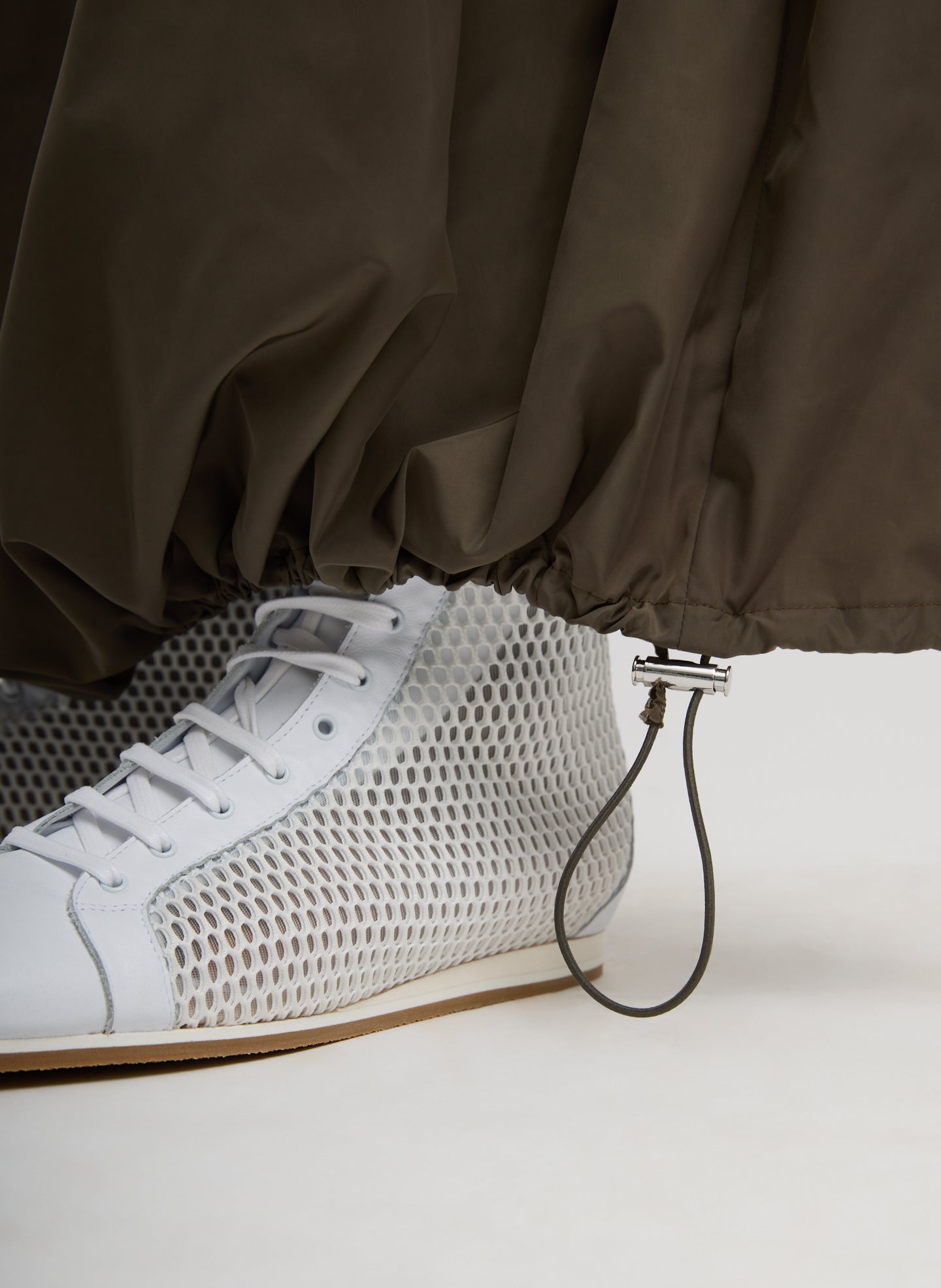 Dark Hazelnut Green Italian Sporty Nylon Maxi Anorak Skirt - closeup of drawstring detail at hem