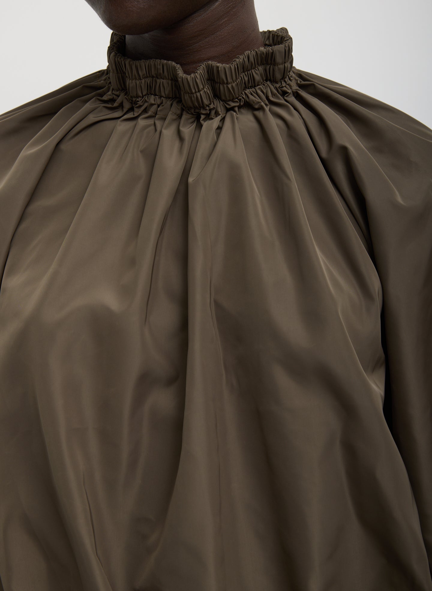 Dark Hazelnut Green Italian Sporty Nylon Shirred Anorak Top - closeup of shirred neck
