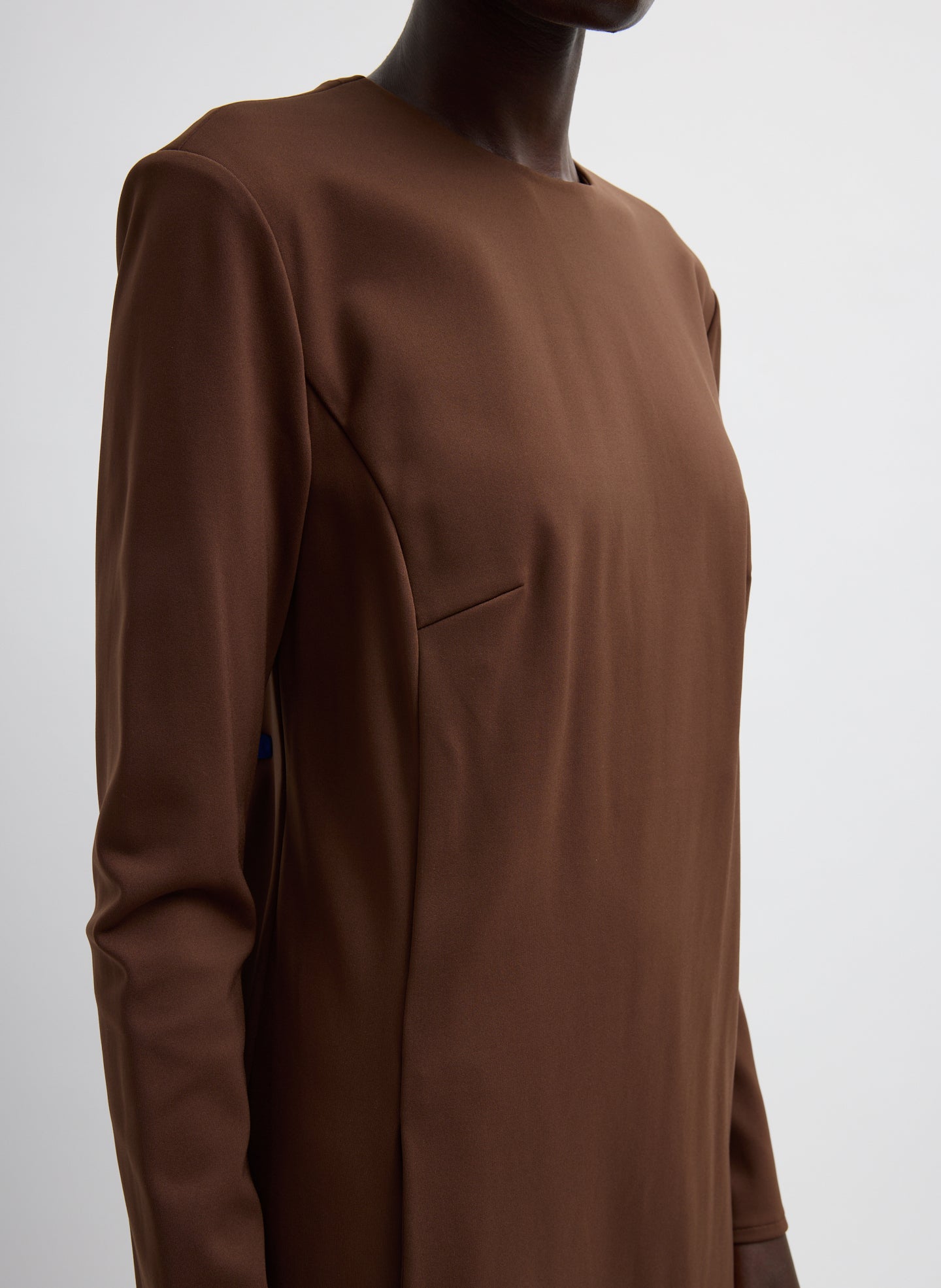 Brown Compact Ultra Stretch Knit Dress With Cut Out Back - closeup of stitching detail at front