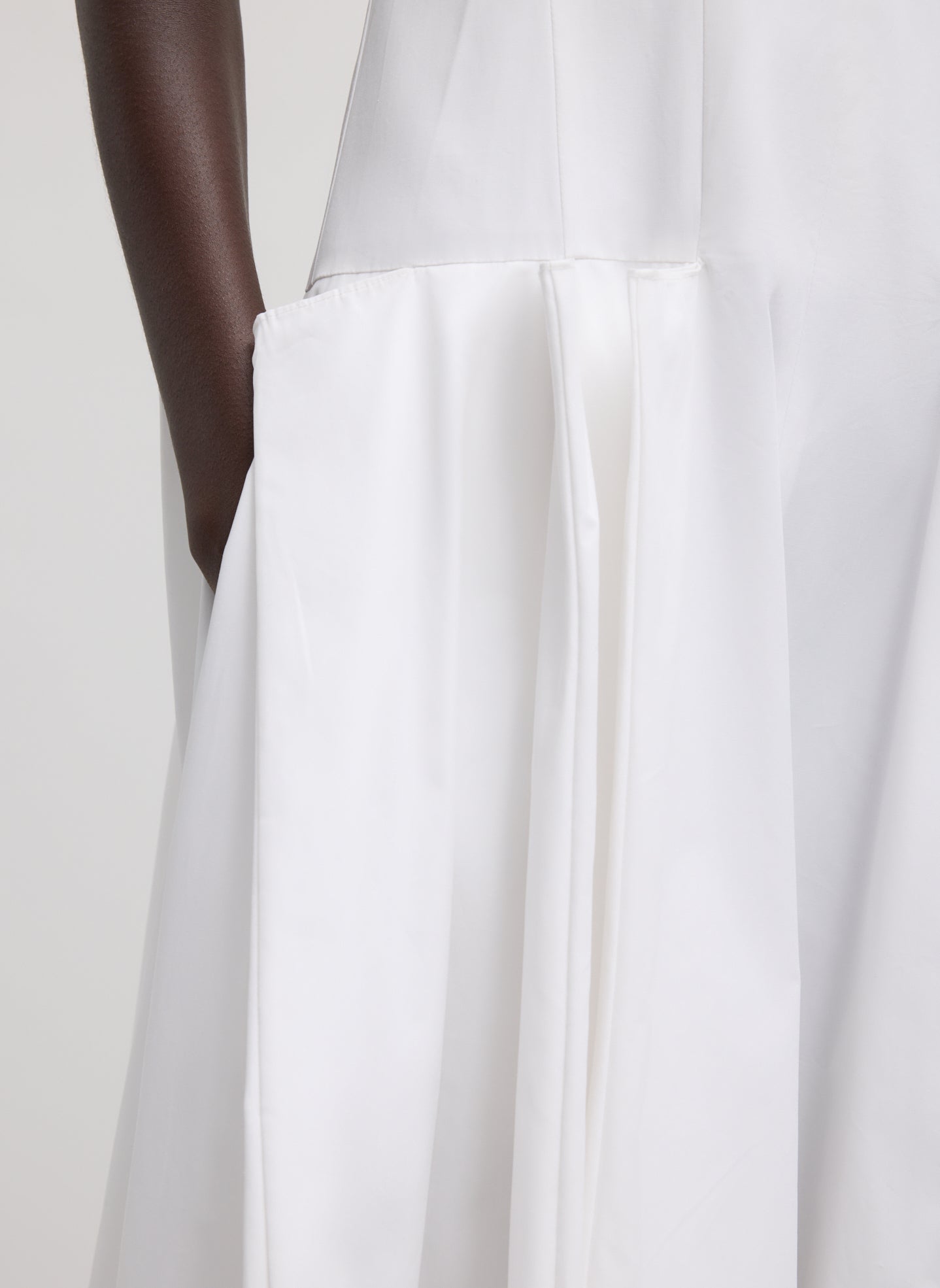 White Compact Eco Poplin Pinched Pleat Dress - closeup of side pocket and pleating detail