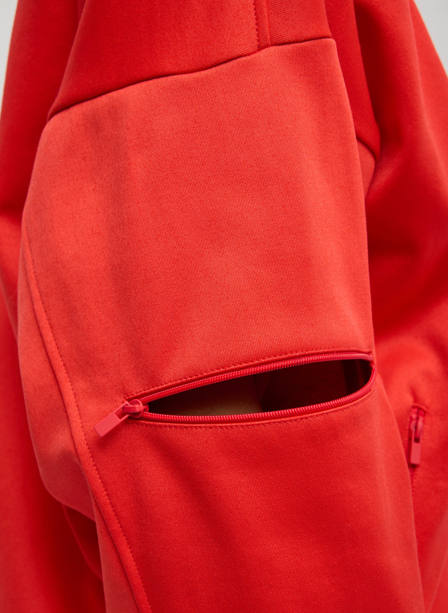 Red Active Knit Zipper Detailed Track Jacket - closeup of zip detail at sleeve
