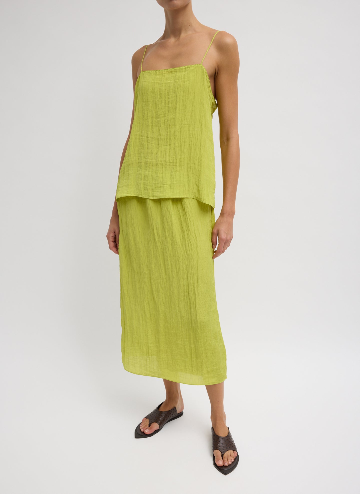 The Crinkle Slip Skirt - Chartreuse Green Crinkle Slip Skirt - silk midi skirt, front view on model