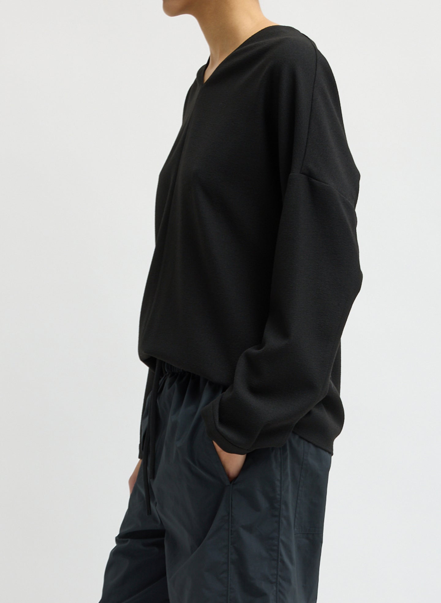 Black Mica Crepe V-Neck Top - long sleeve blouse, side view on model