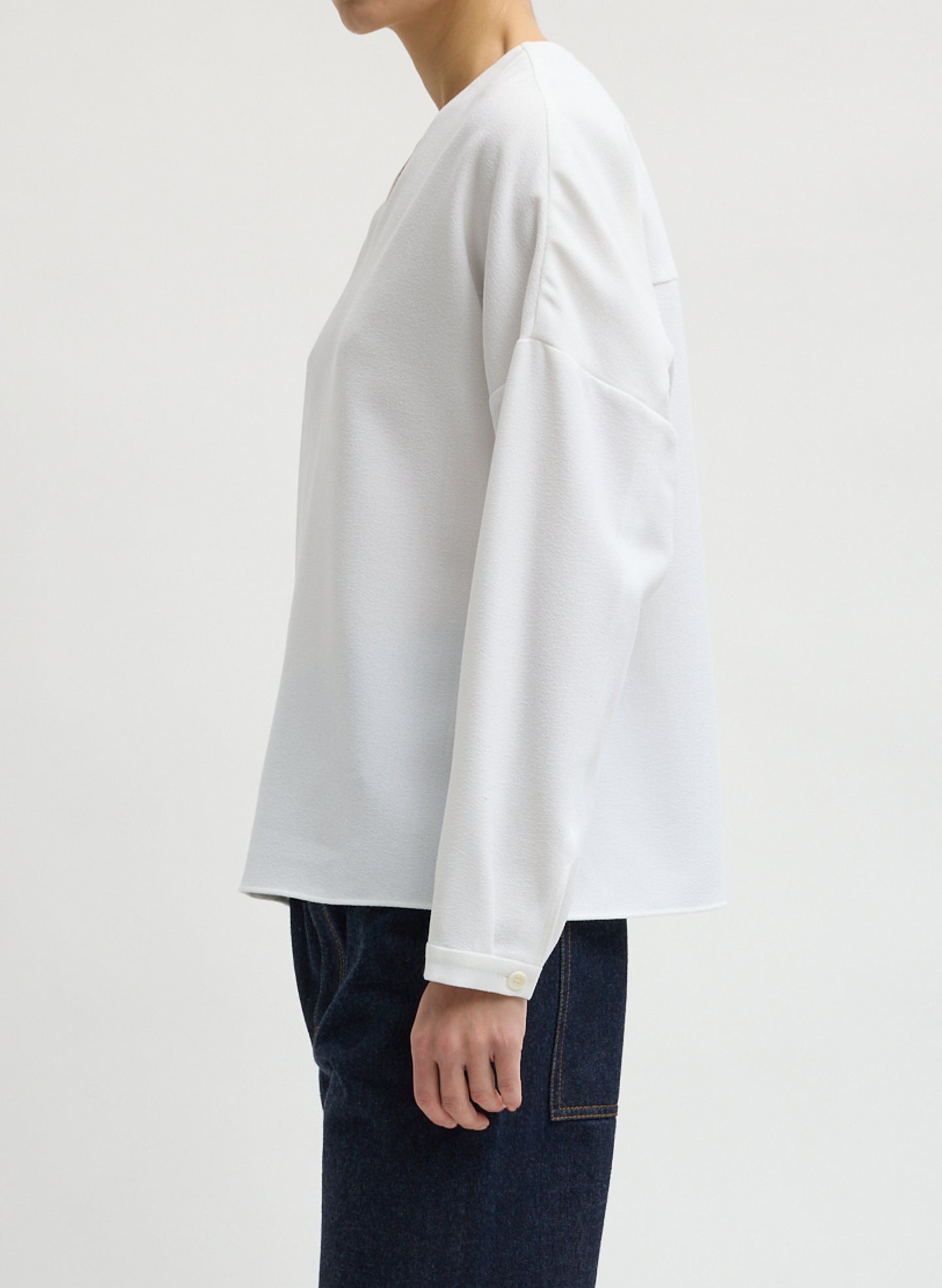White Mica Crepe V-Neck Top - long sleeve blouse, side view on model