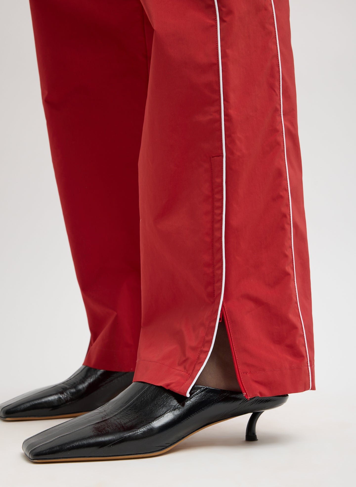 Red Nylon Piped Jogger - closeup of hem detail