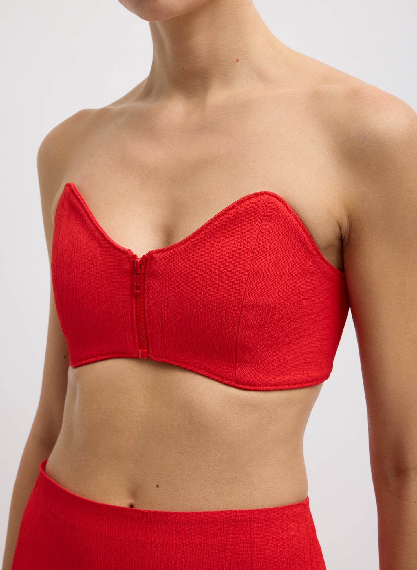 Red Creased Stretch Crepe Strapless Bralette - closeup of zip front detail