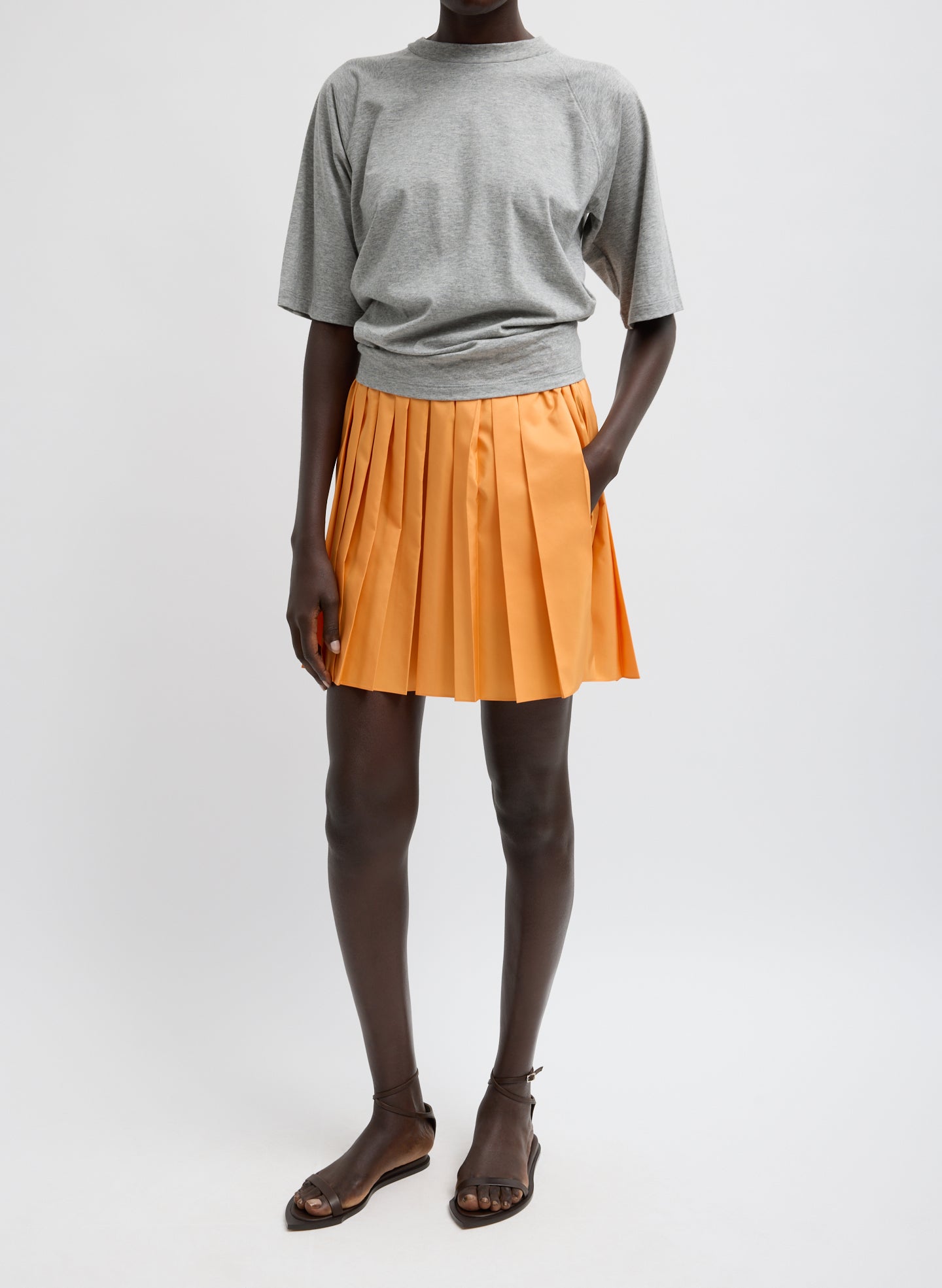 Summer Nylon Pull On Mini Skirt - Orange Summer Nylon Pleated Mini Skirt - full look, front view on model