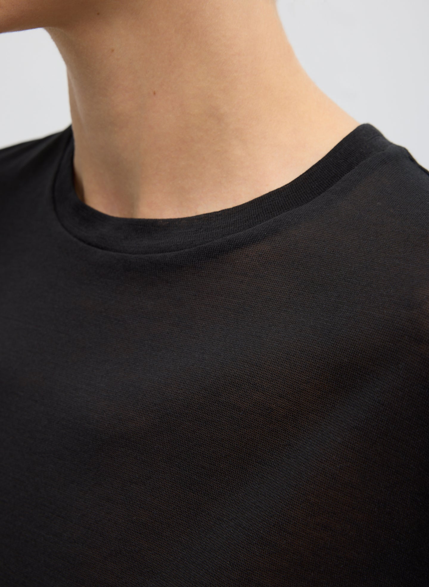 Black Sheer Crepe Knit Mock Neck Unisex T-Shirt - closeup of neckline