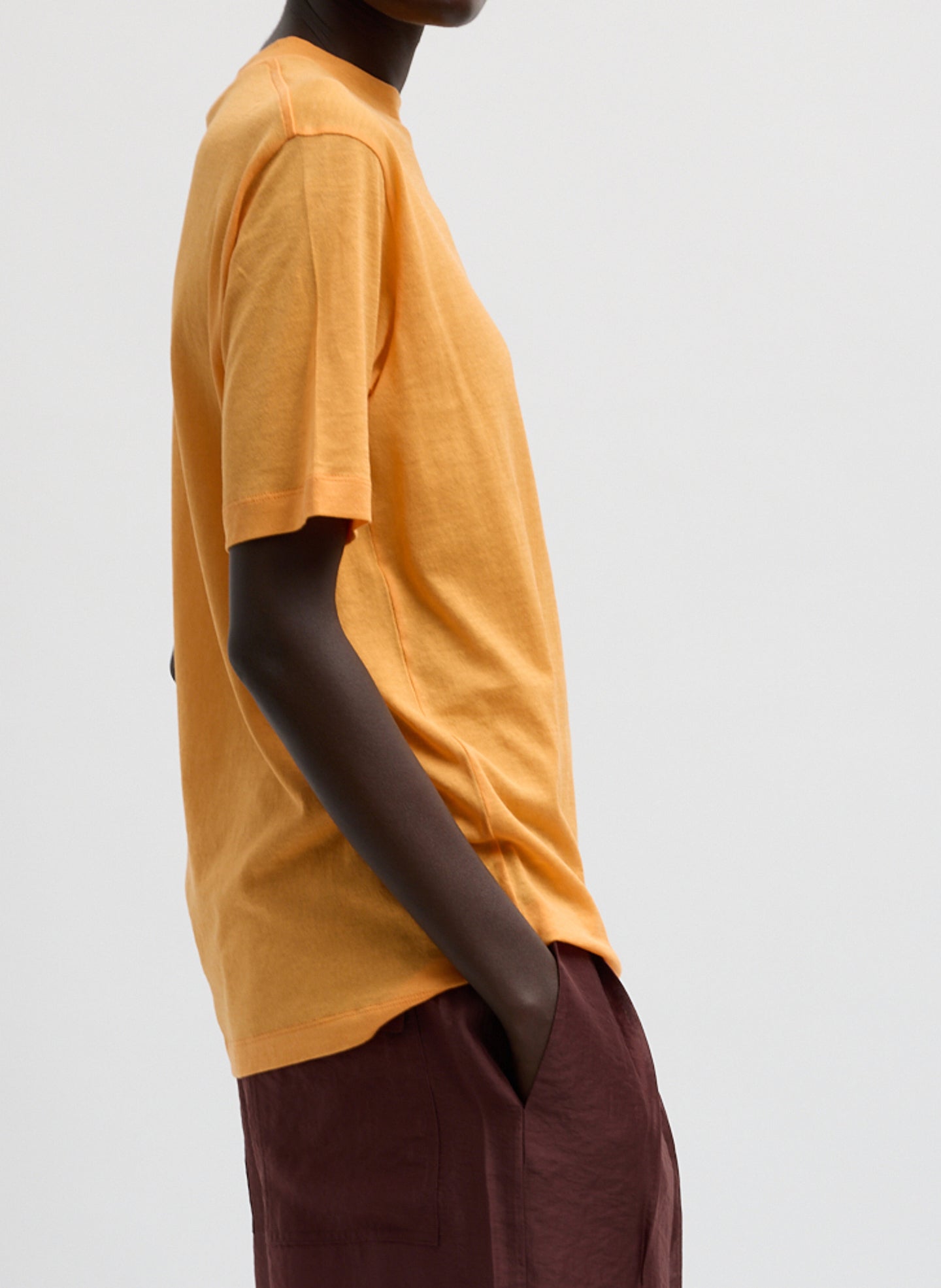 Orange Sheer Crepe Knit Mock Neck Unisex T-Shirt - side view on model