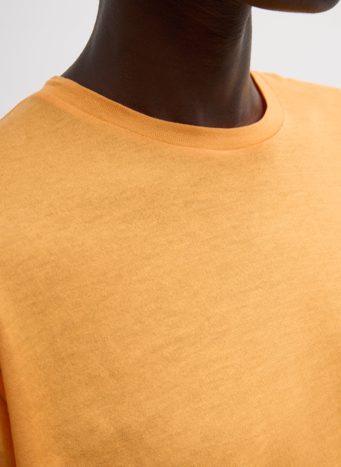 Orange Sheer Crepe Knit Mock Neck Unisex T-Shirt - closeup of neckline