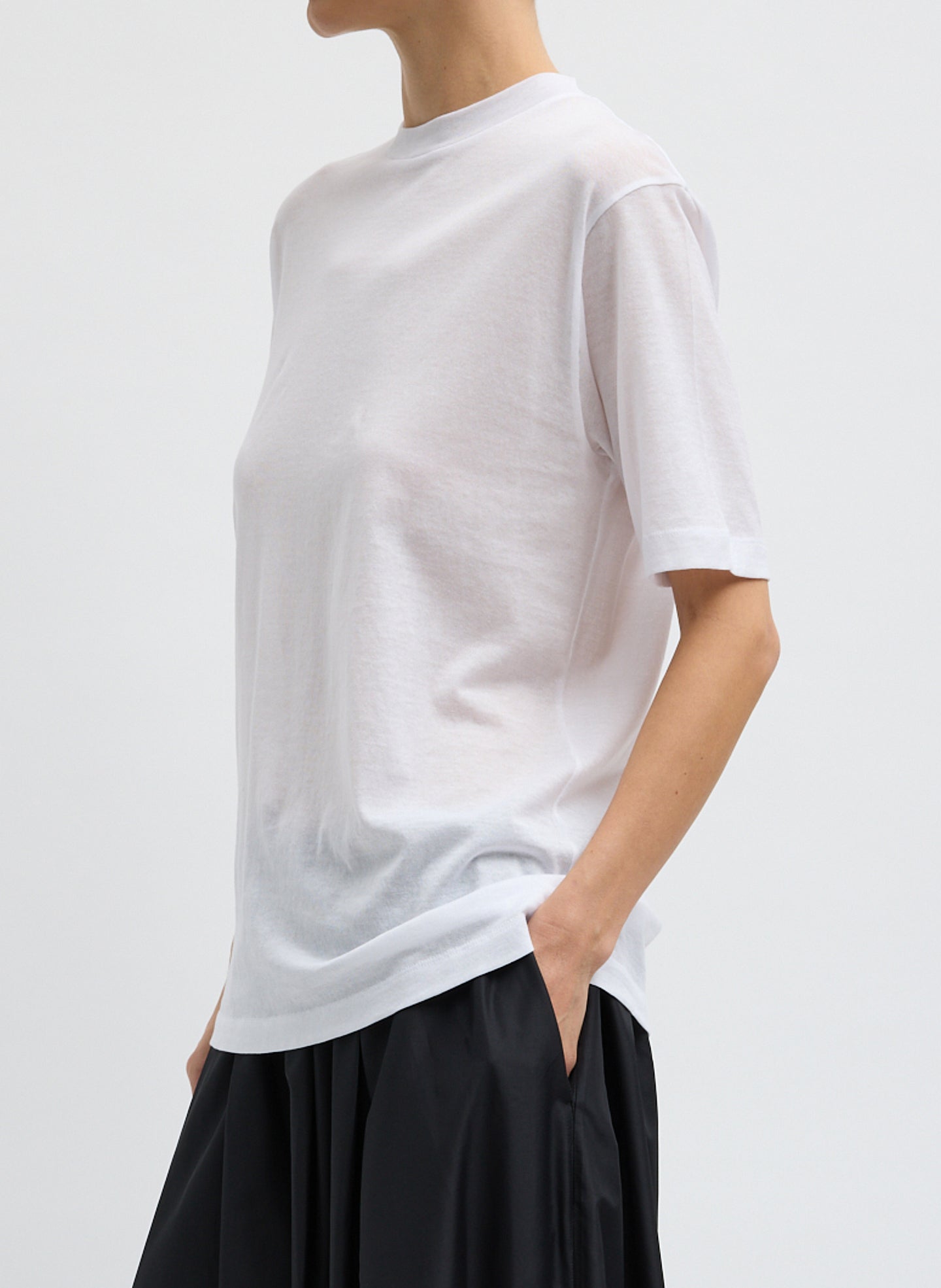 White Sheer Crepe Knit Mock Neck Unisex T-Shirt - side view on model