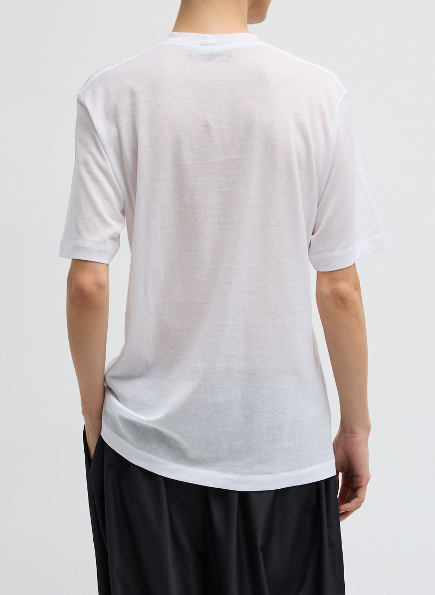 White Sheer Crepe Knit Mock Neck Unisex T-Shirt - back view on model