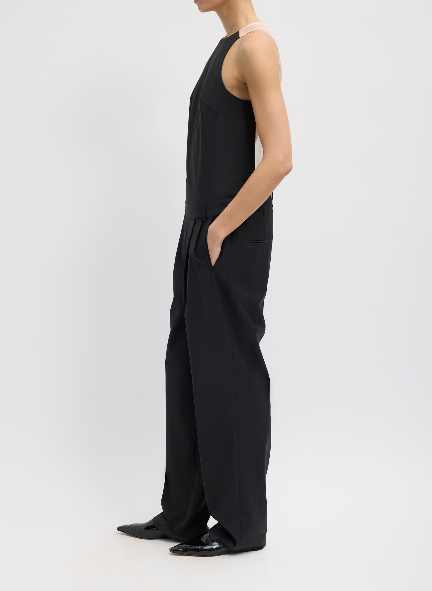 Black Recycled Tropical Wool Jumpsuit - sheer organza back, side view on model