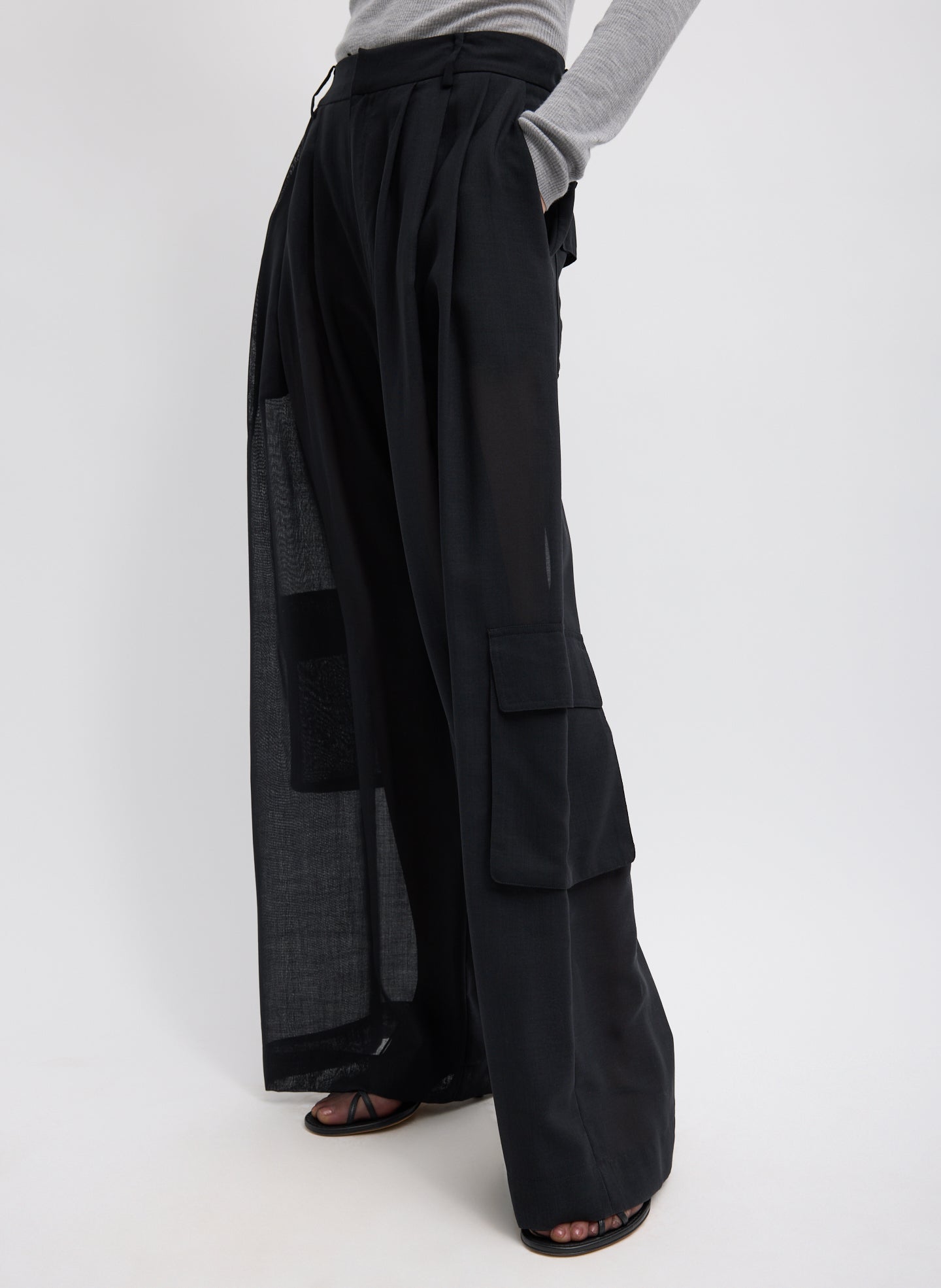 Black Sheer Wool Gauze Triple Pleat Pant – closeup of pockets, side view on model 